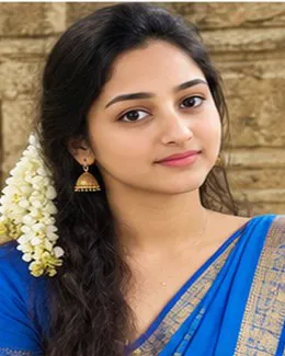 Anjali in a royal blue saree, a long jasmine braid falling over her shoulder