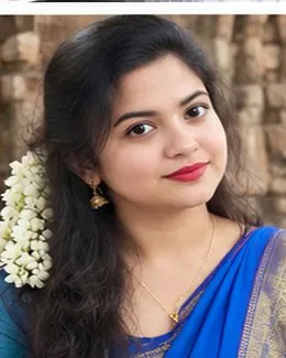 Lakshmi in a blue saree, white jasmine framing her face